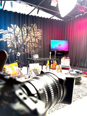 Room with a TV screen, table setup, and camera lens in the foreground